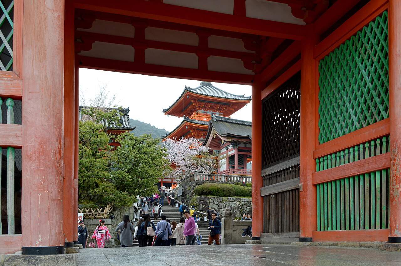 The West Gate and three-storied pagoda of Kiyomizu-dera seen through the Niomon gate